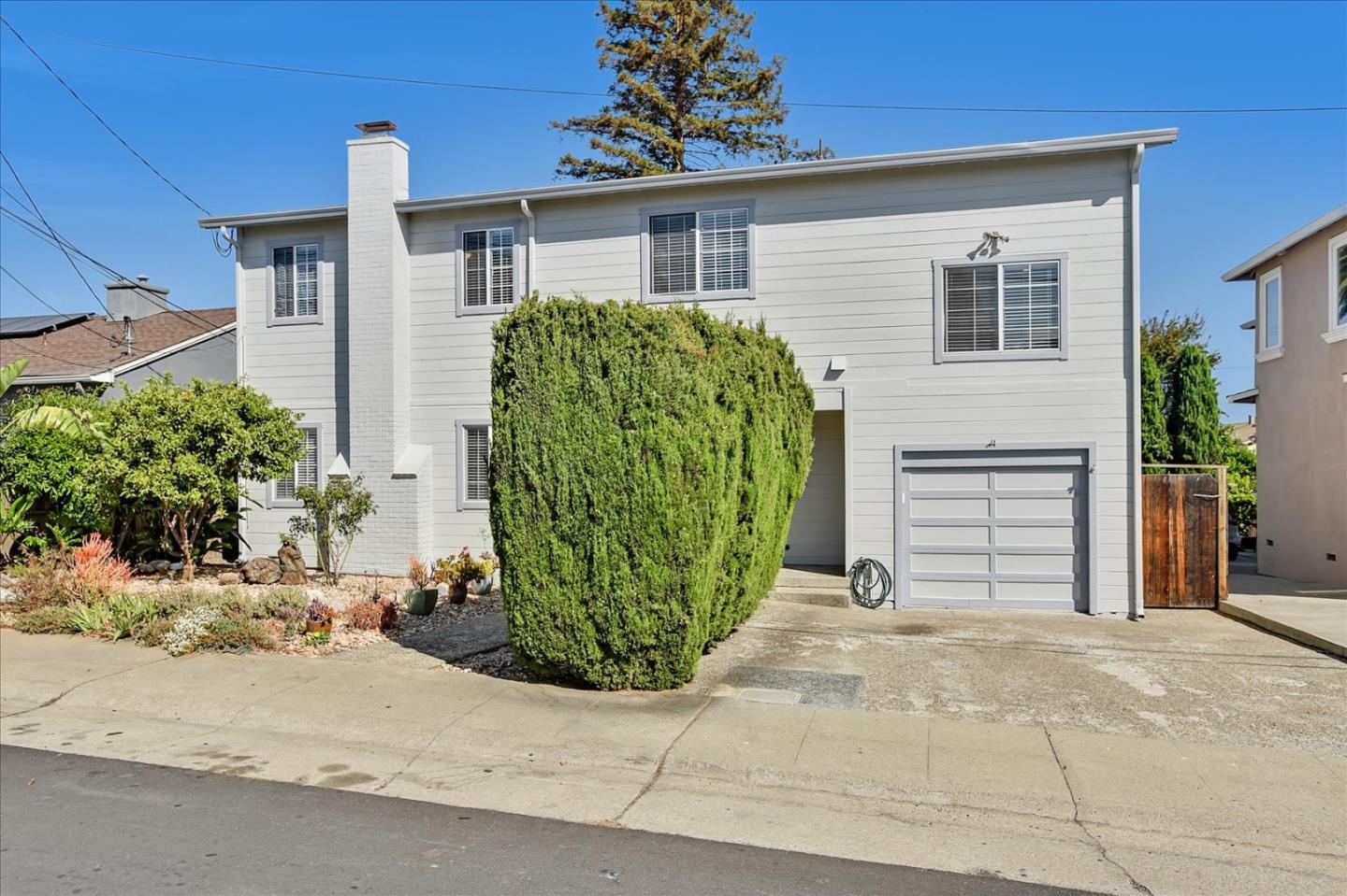 64 Darcy Avenue San Mateo, CA 94403 - Photo 2 of 54 a front view of a house with garden