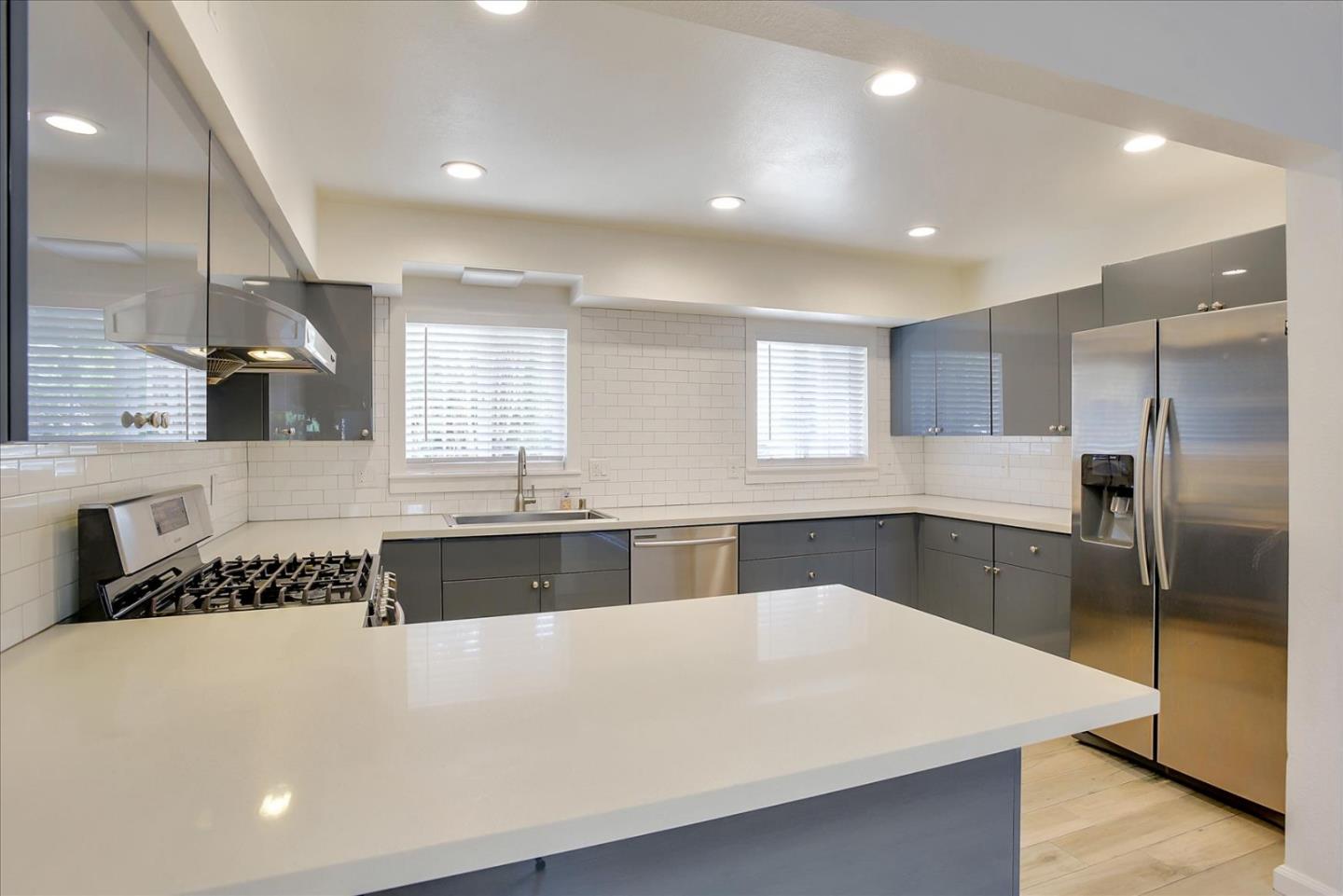 64 Darcy Avenue San Mateo, CA 94403 - Photo 13 of 54 a large white kitchen with a large window