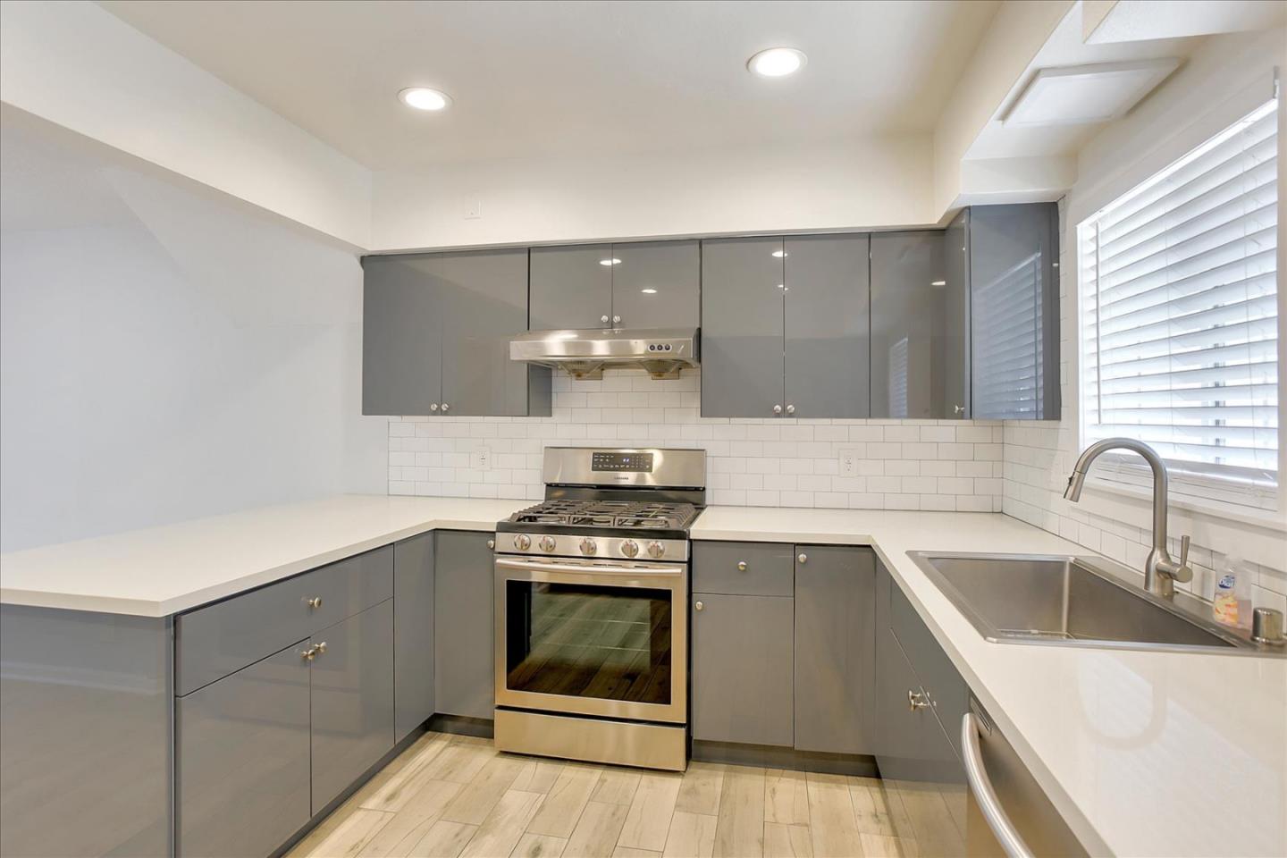 64 Darcy Avenue San Mateo, CA 94403 - Photo 15 of 54 a kitchen with stainless steel appliances granite countertop a sink stove and cabinets