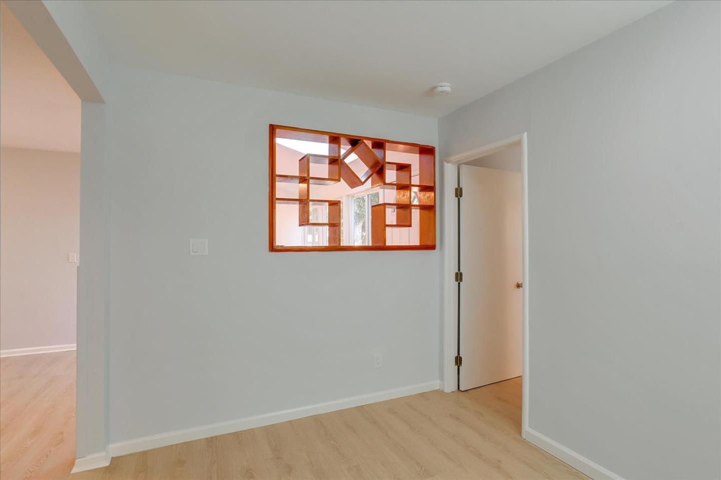 64 Darcy Avenue San Mateo, CA 94403 - Photo 17 of 54 a view of an empty room with wooden floor and a window
