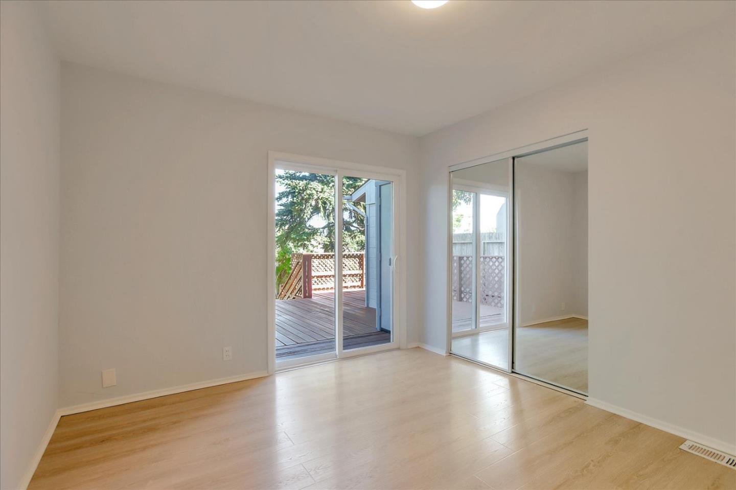 64 Darcy Avenue San Mateo, CA 94403 - Photo 26 of 54 an empty room with wooden floor and windows