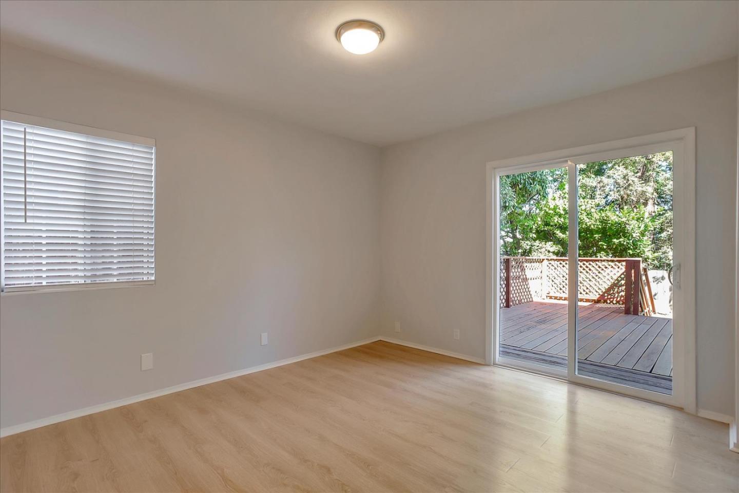 64 Darcy Avenue San Mateo, CA 94403 - Photo 27 of 54 an empty room with wooden floor and windows