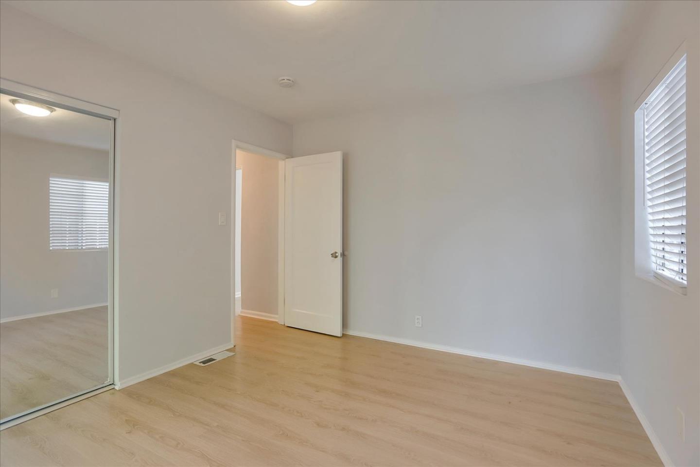 64 Darcy Avenue San Mateo, CA 94403 - Photo 28 of 54 an empty room with wooden floor and windows