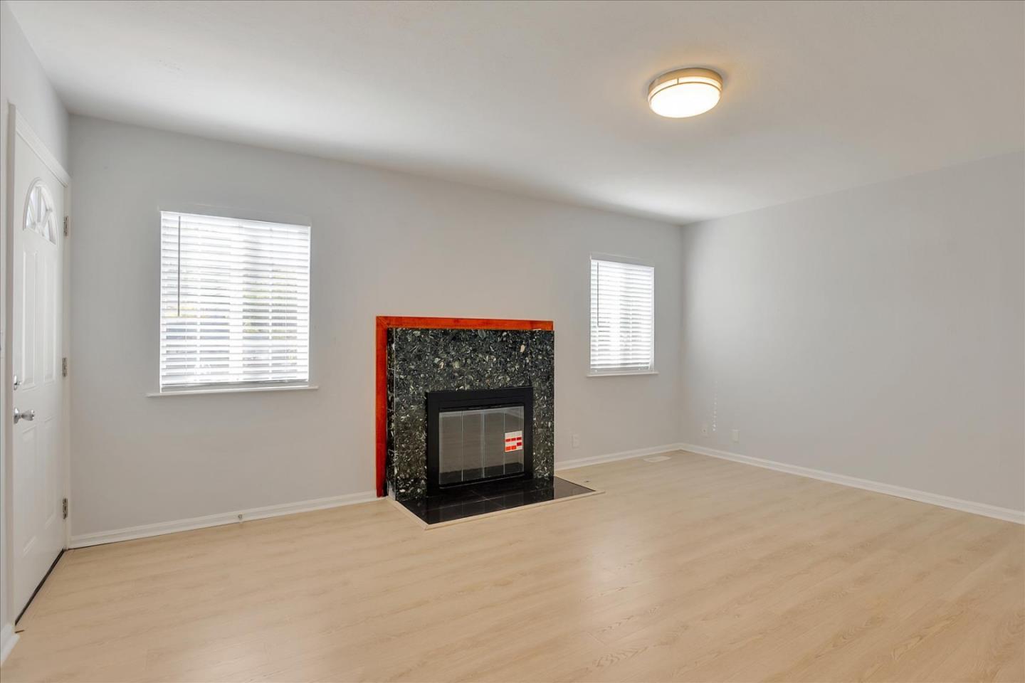 64 Darcy Avenue San Mateo, CA 94403 - Photo 4 of 54 an empty room with a window and a fireplace