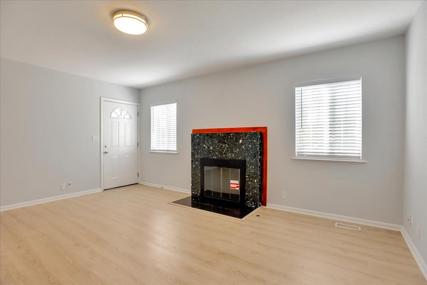 64 Darcy Avenue San Mateo, CA 94403 - Photo 5 of 54 an empty room with a window and fireplace