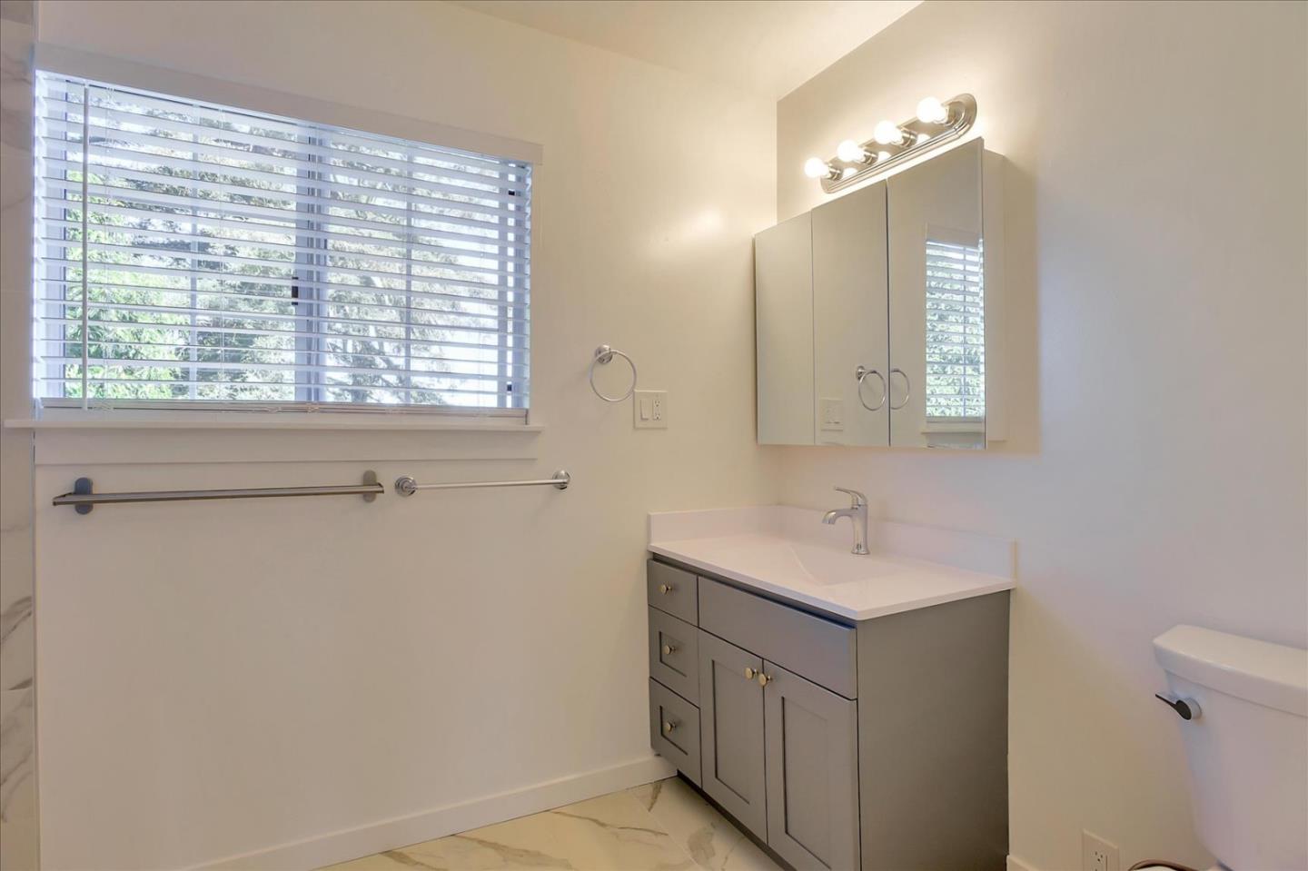 64 Darcy Avenue San Mateo, CA 94403 - Photo 44 of 54 a bathroom with a sink a toilet and mirror