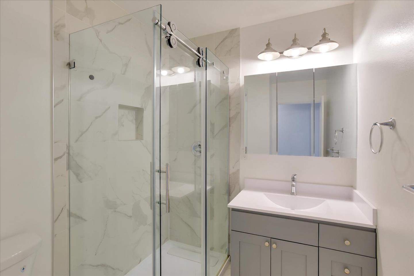 64 Darcy Avenue San Mateo, CA 94403 - Photo 45 of 54 a bathroom with a shower sink and mirror