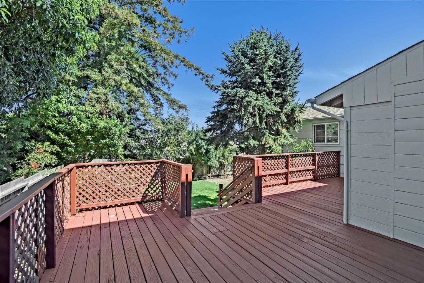 64 Darcy Avenue San Mateo, CA 94403 - Photo 49 of 54 a view of a wooden deck with a bench and wooden floor