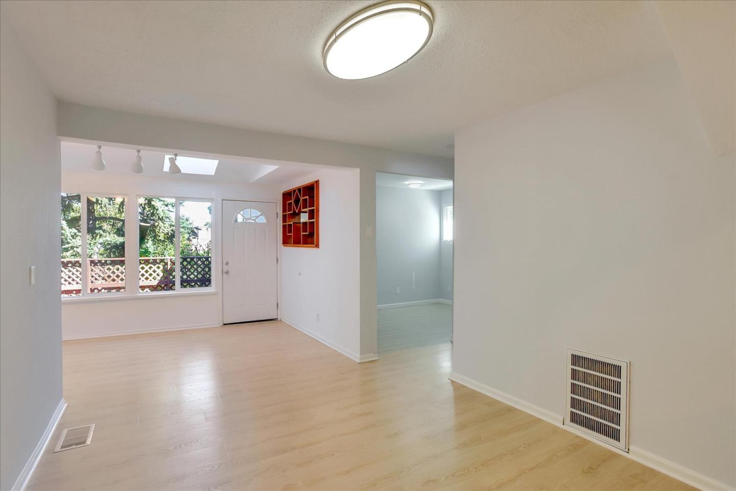 64 Darcy Avenue San Mateo, CA 94403 - Photo 10 of 54 an empty room with wooden floor and windows