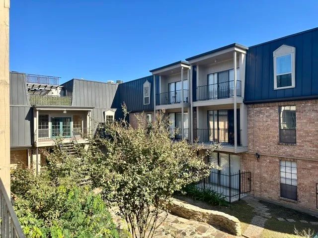 a front view of a residential apartment building with a yard