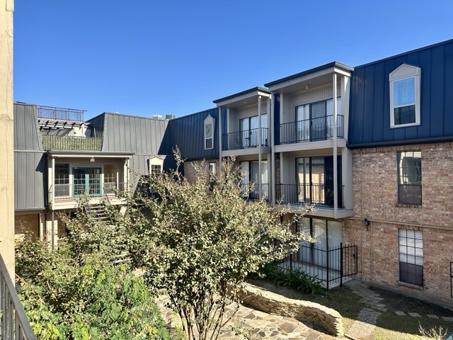 a front view of a residential apartment building with a yard