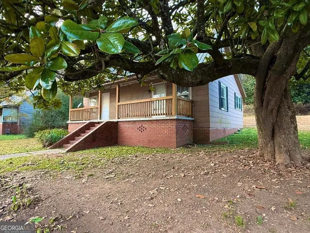 a view of a house with a tree