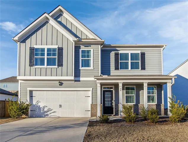 a view of a house with a yard and plants
