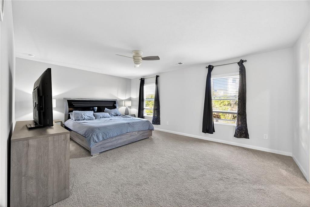 56 Berwick Crossing Dallas, GA 30157 - Photo 18 of 28 a spacious bedroom with a bed and a fireplace