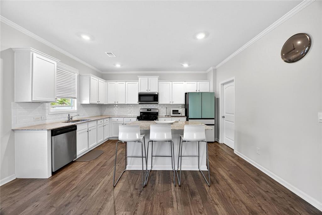 56 Berwick Crossing Dallas, GA 30157 - Photo 5 of 28 a kitchen with white cabinets and stainless steel appliances