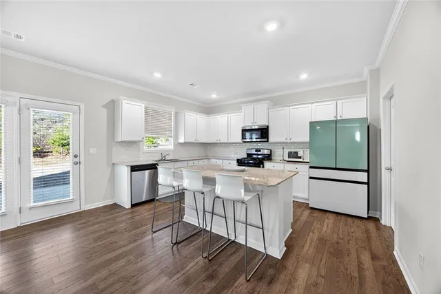 a kitchen with white cabinets and white appliances