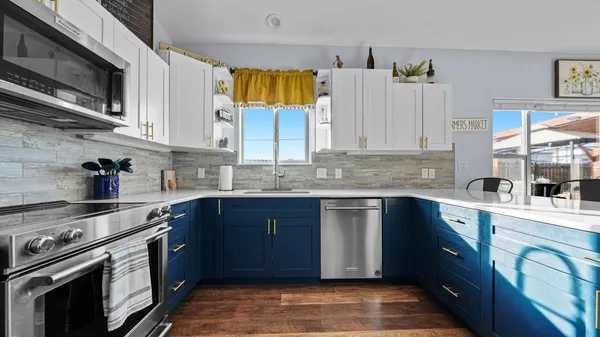 a kitchen with stainless steel appliances granite countertop a stove a sink and a microwave