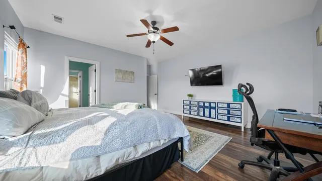 a bedroom with a bed and a chandelier