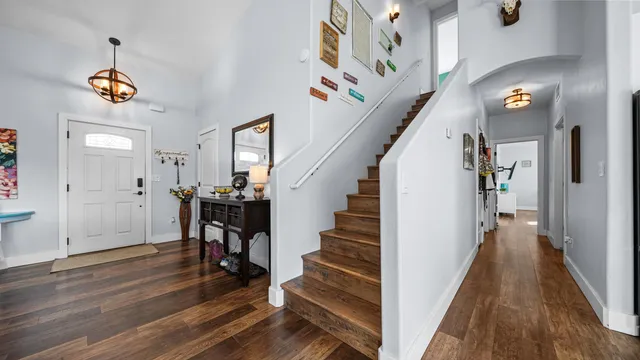 a view of entryway and hall with wooden floor