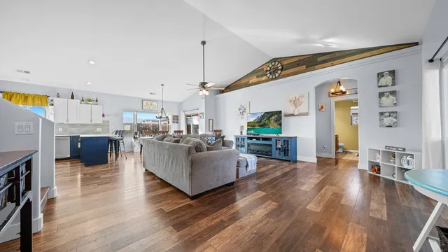 a living room with fireplace furniture and a wooden floor