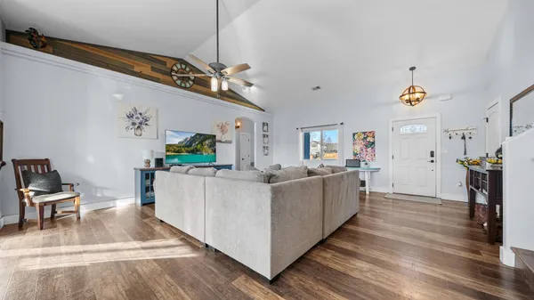 a living room with furniture and a kitchen view