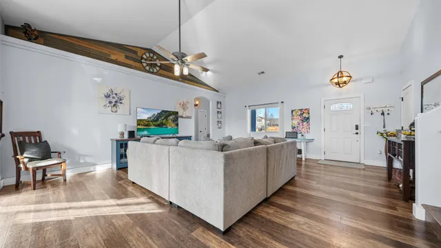 a living room with furniture and a kitchen view