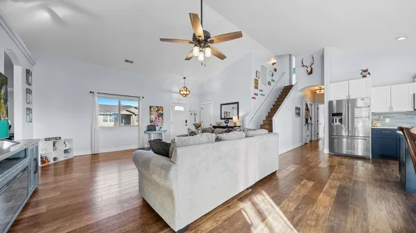 a living room with fireplace furniture and a wooden floor