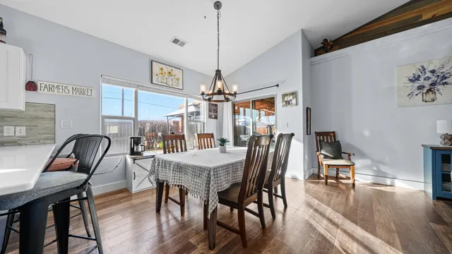 a dining room with furniture and wooden floor