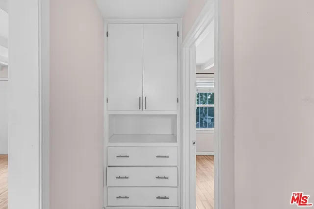 a view of walk in closet with empty racks