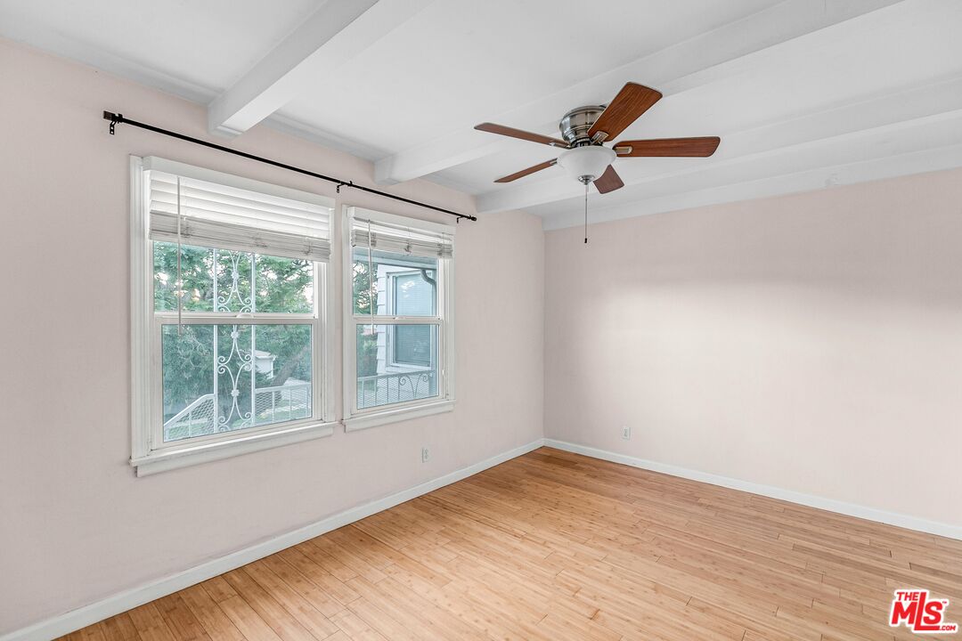 3996 Berryman Avenue Los Angeles, CA 90066 - Photo 13 of 17 a view of empty room with wooden floor and fan