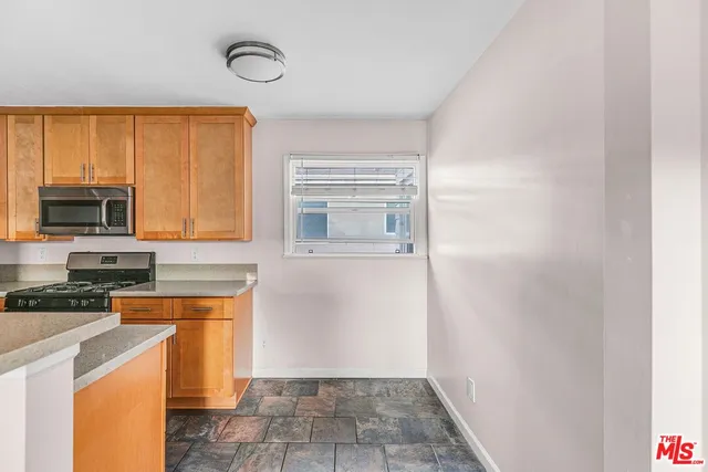 a kitchen with a stove a sink and a microwave