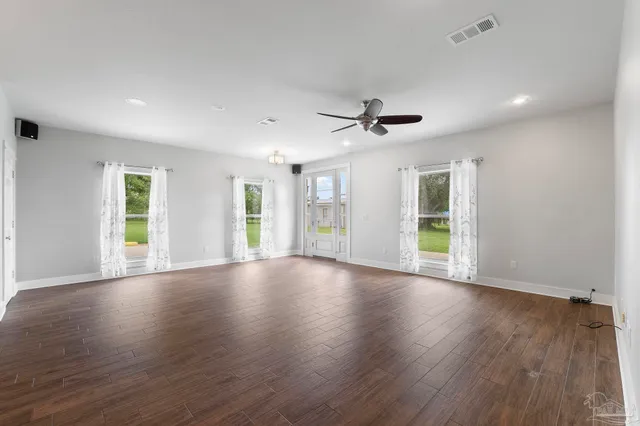 a view of a livingroom with a ceiling fan and window