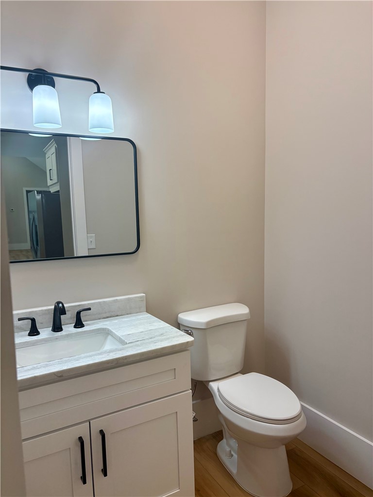 854 Perkins Creek Road Seneca, SC 29678 - Photo 26 of 34 A classic vanity with stone counters and modern fixtures highlights this functional powder room.
