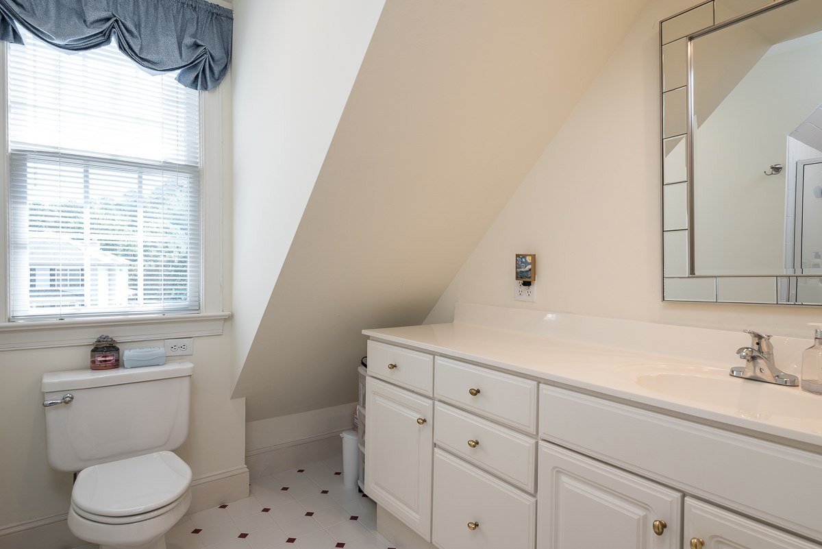 1905 Russell Drive Raleigh, NC 27612 - Photo 20 of 30 Private Bath for Bedroom 4/Bonus with white cabinets and vanity, shower and tile floors. Bathroom