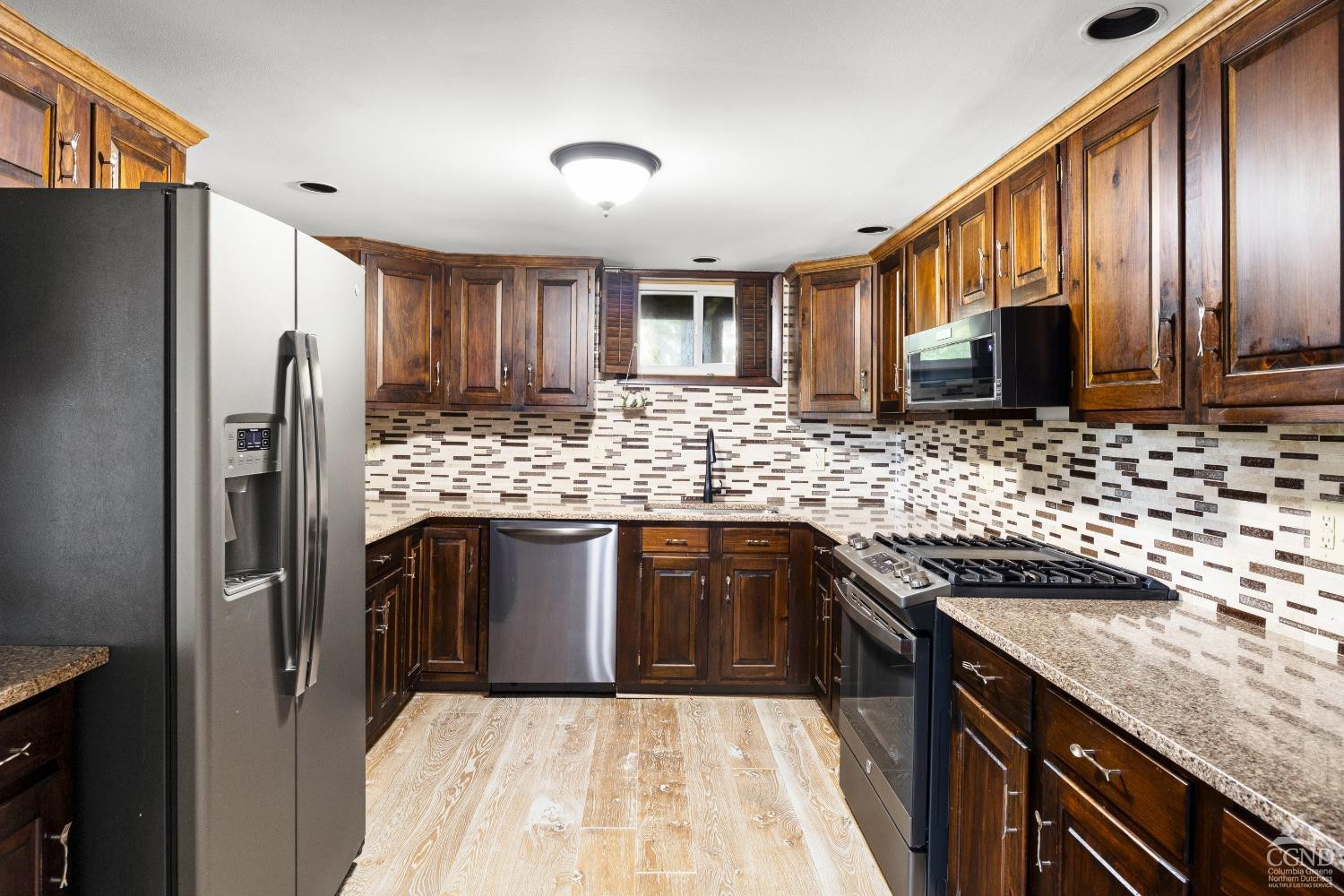 1264 Lakeview Road Copake, NY 12516 - Photo 6 of 24 a kitchen with stainless steel appliances granite countertop a sink stove and refrigerator