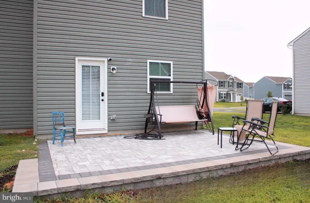 a view of a patio with chairs and a table