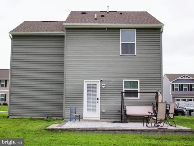 a front view of a house with a yard and plants