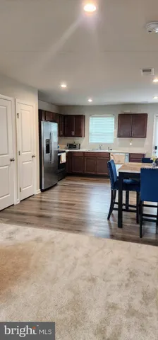 a view of a livingroom with furniture and a flat screen tv