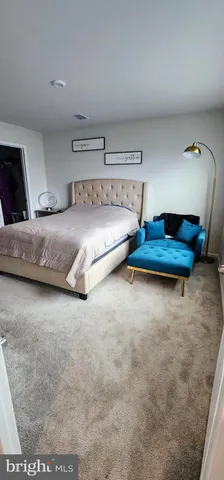 a bedroom with a bed and a night stand