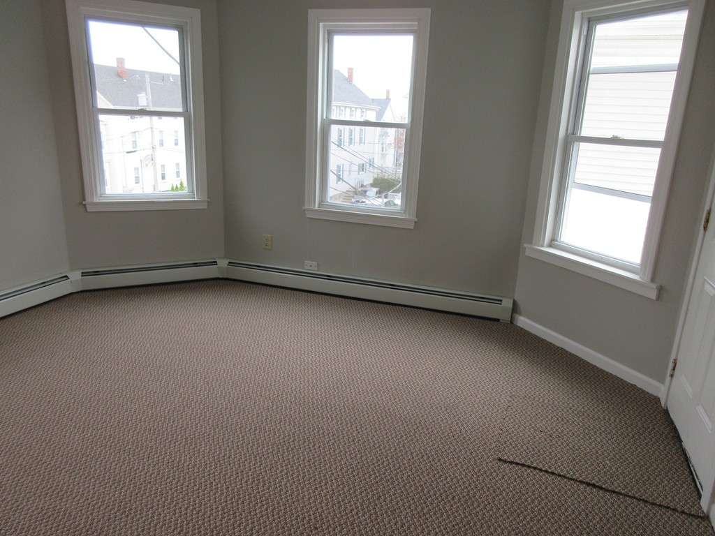405 5th Street Fall River, MA 02721 - Photo 3 of 22 an empty room with a window