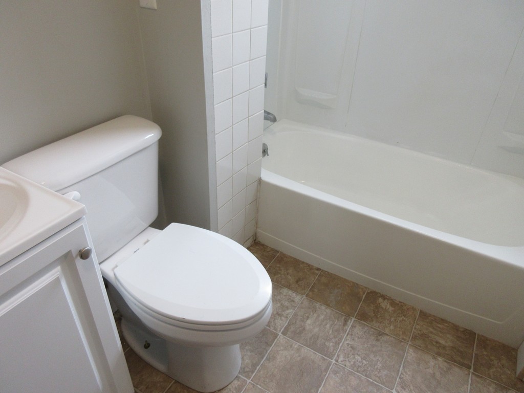 405 5th Street Fall River, MA 02721 - Photo 5 of 22 a white toilet sitting next to a bath tub