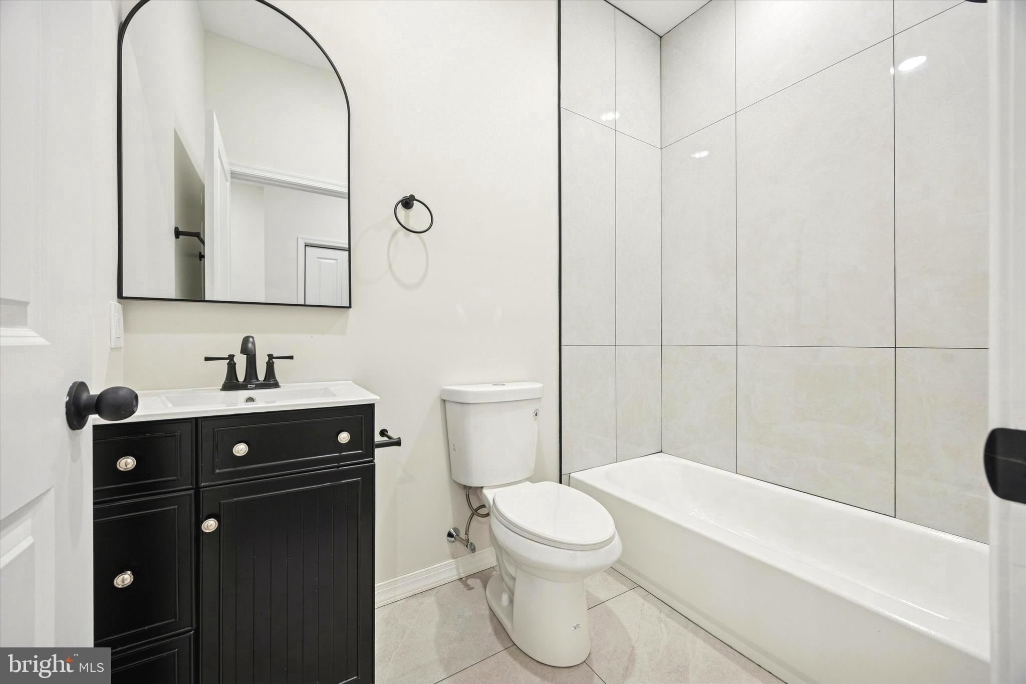 1326 North Frazier Street Philadelphia, PA 19131 - Photo 15 of 40 a bathroom with a sink a toilet and shower