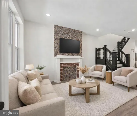 a living room with furniture a fireplace and a flat screen tv
