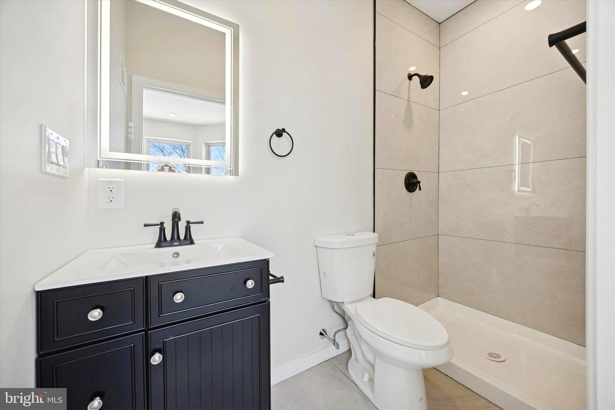 1326 North Frazier Street Philadelphia, PA 19131 - Photo 21 of 40 a bathroom with a sink a toilet and shower