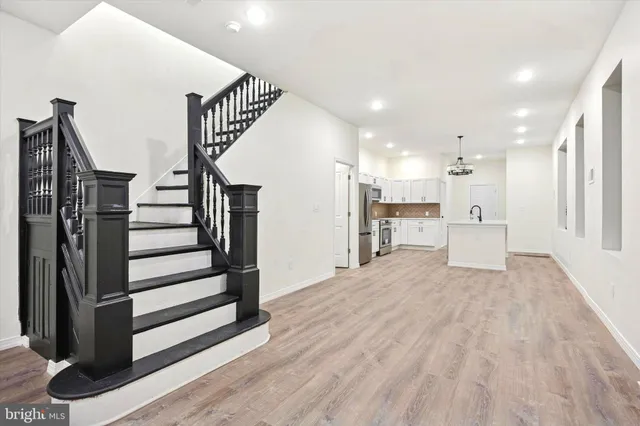 a view of a kitchen with wooden floor and stairs