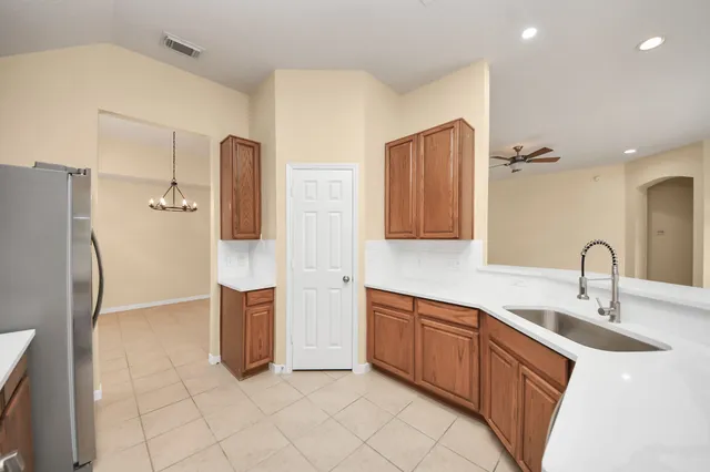 a kitchen with stainless steel appliances a refrigerator sink and cabinets