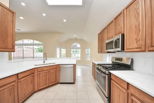 a kitchen with a sink stove top oven and cabinets