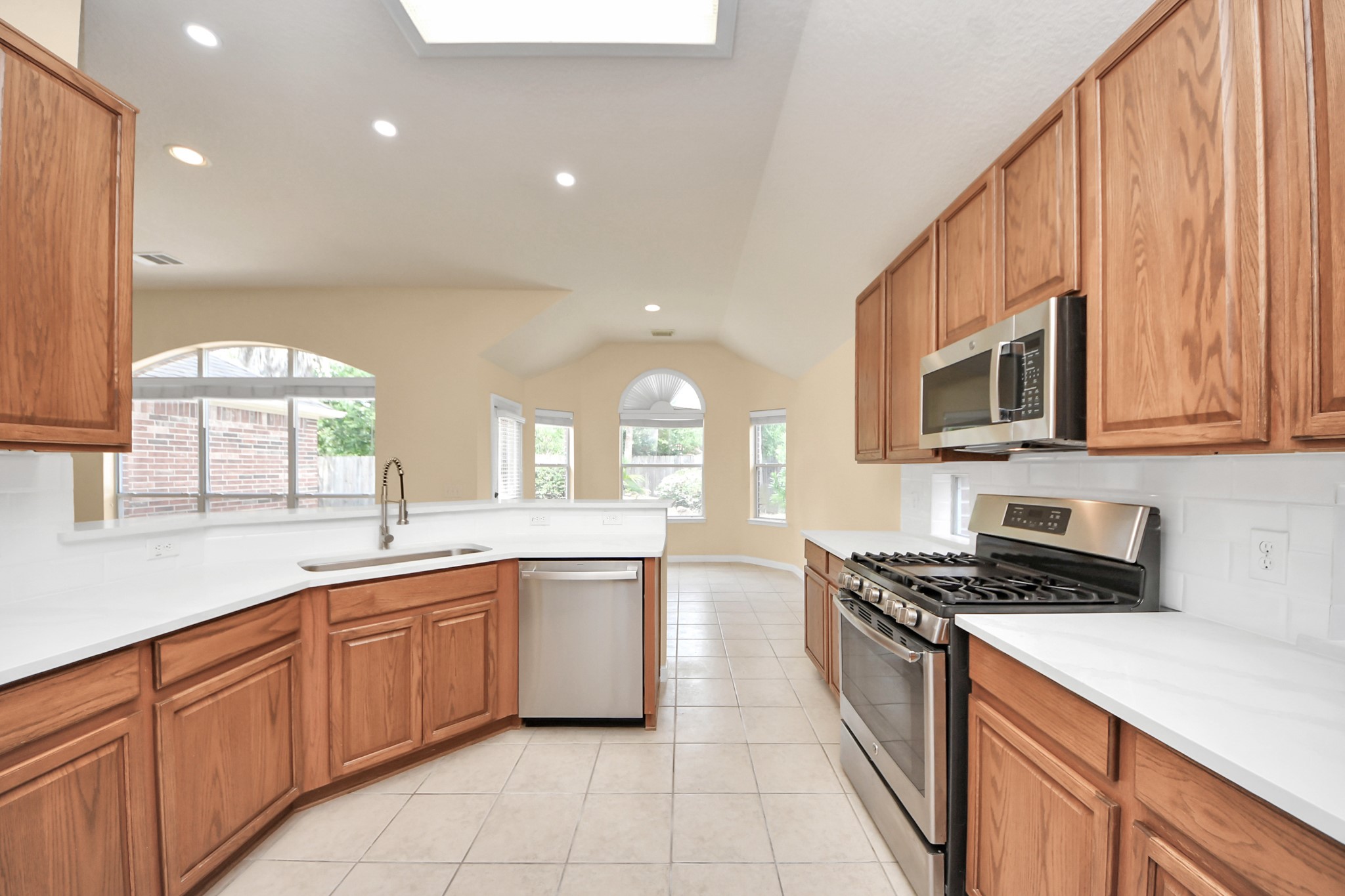 20011 Rosswood Lane Spring, TX 77388 - Photo 14 of 26 a kitchen with a sink stove top oven and cabinets