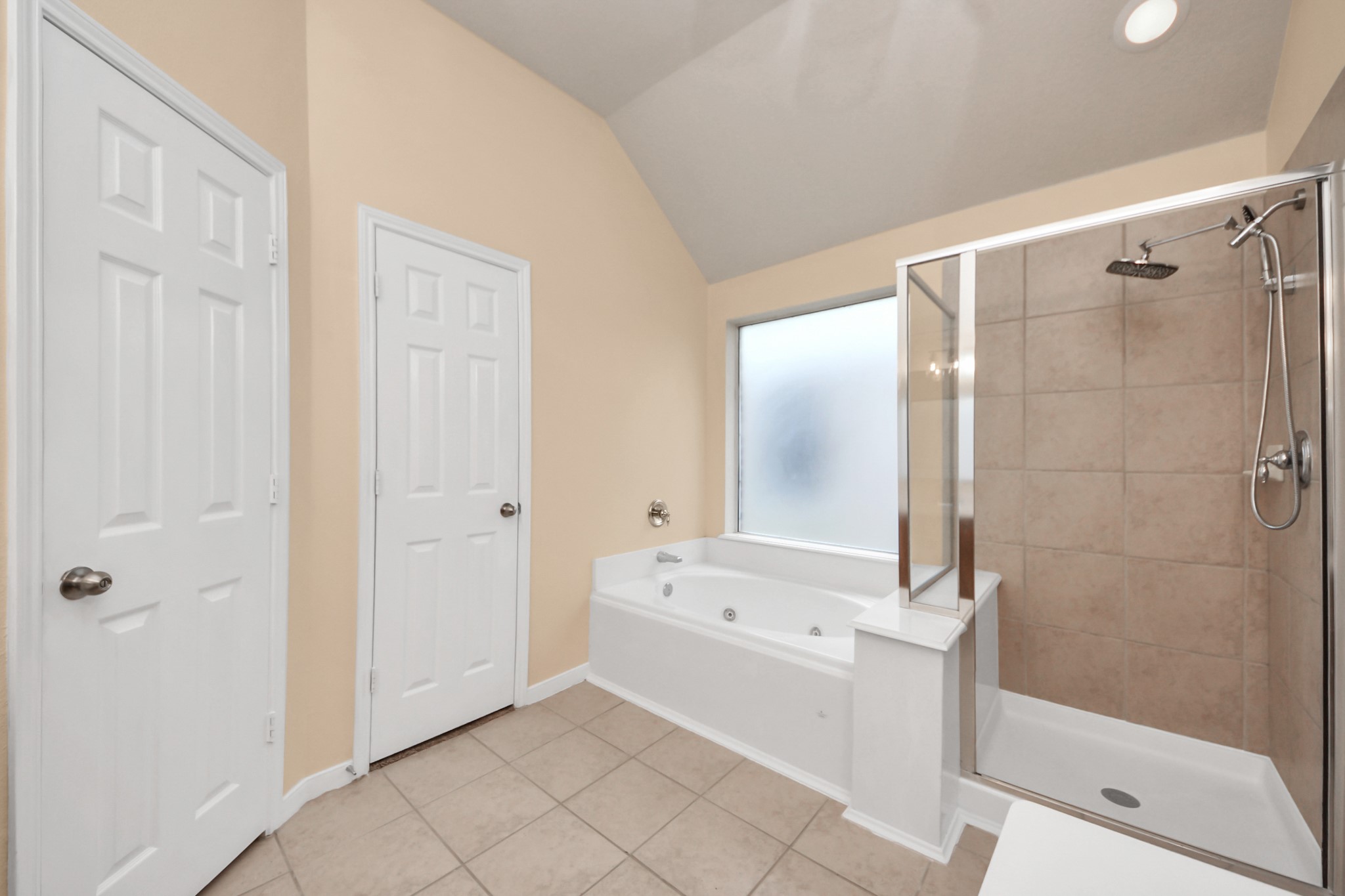 20011 Rosswood Lane Spring, TX 77388 - Photo 19 of 26 a bathroom with a bathtub and a shower