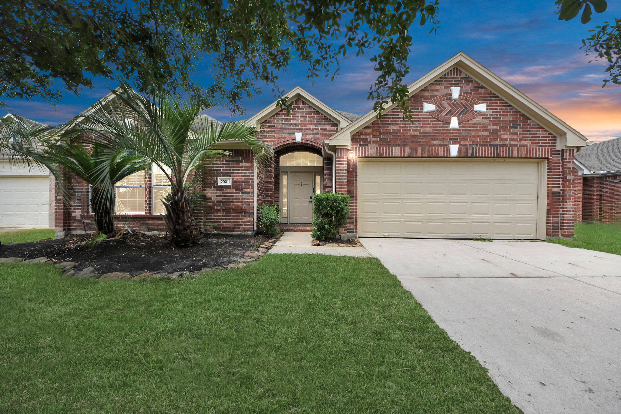 20011 Rosswood Lane Spring, TX 77388 - Photo 2 of 26 a front view of a house with a garden and plants